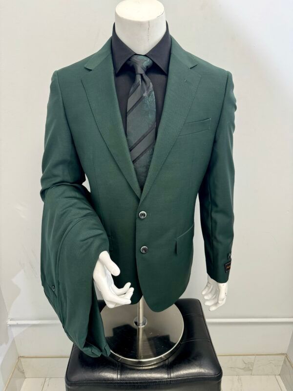 A mannequin is wearing a green suit and tie
