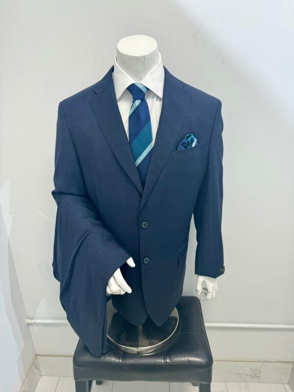 A mannequin is wearing a blue suit and tie