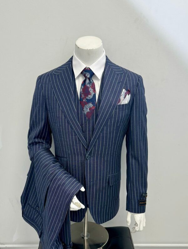 A mannequin is wearing a blue striped suit and tie.