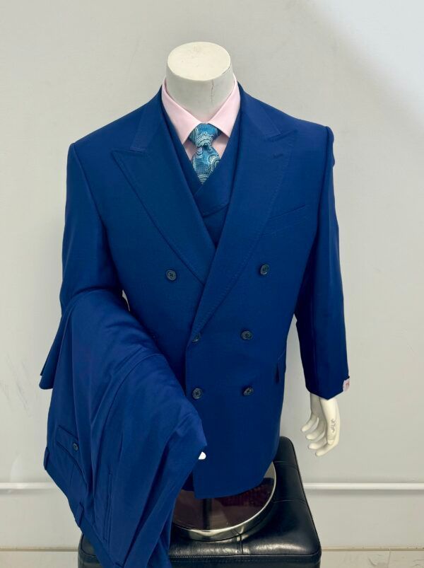 A mannequin is wearing a blue suit and tie
