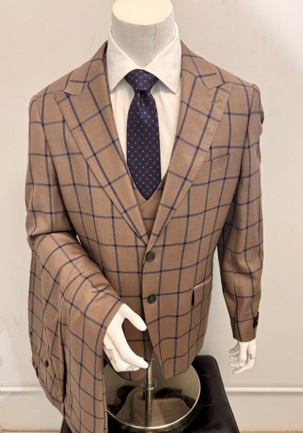 A mannequin is wearing a suit and tie.