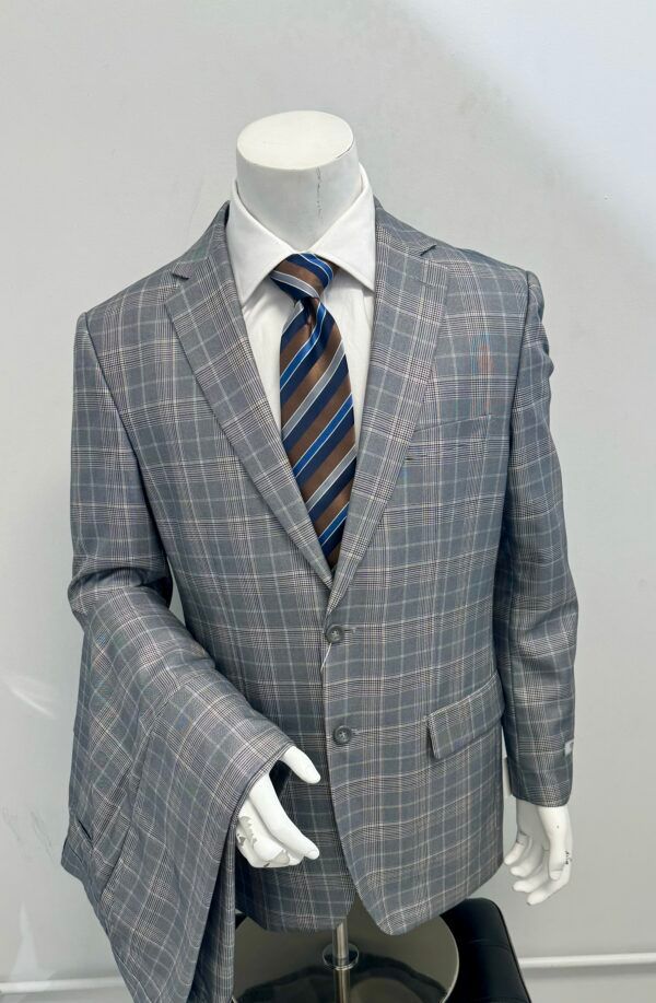 A man is wearing a suit and tie on a mannequin.