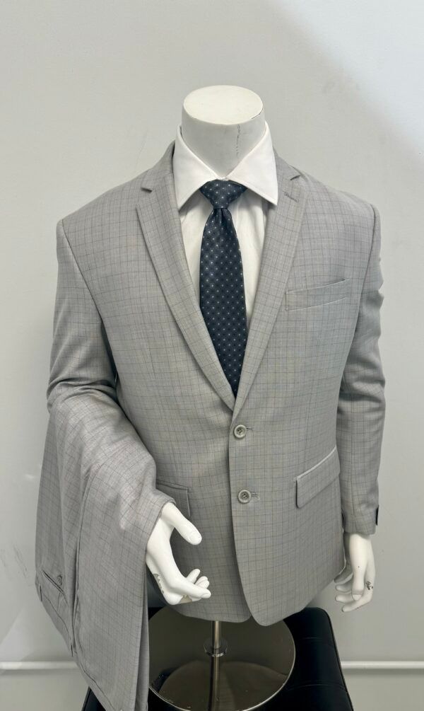 A mannequin is wearing a grey suit and tie.