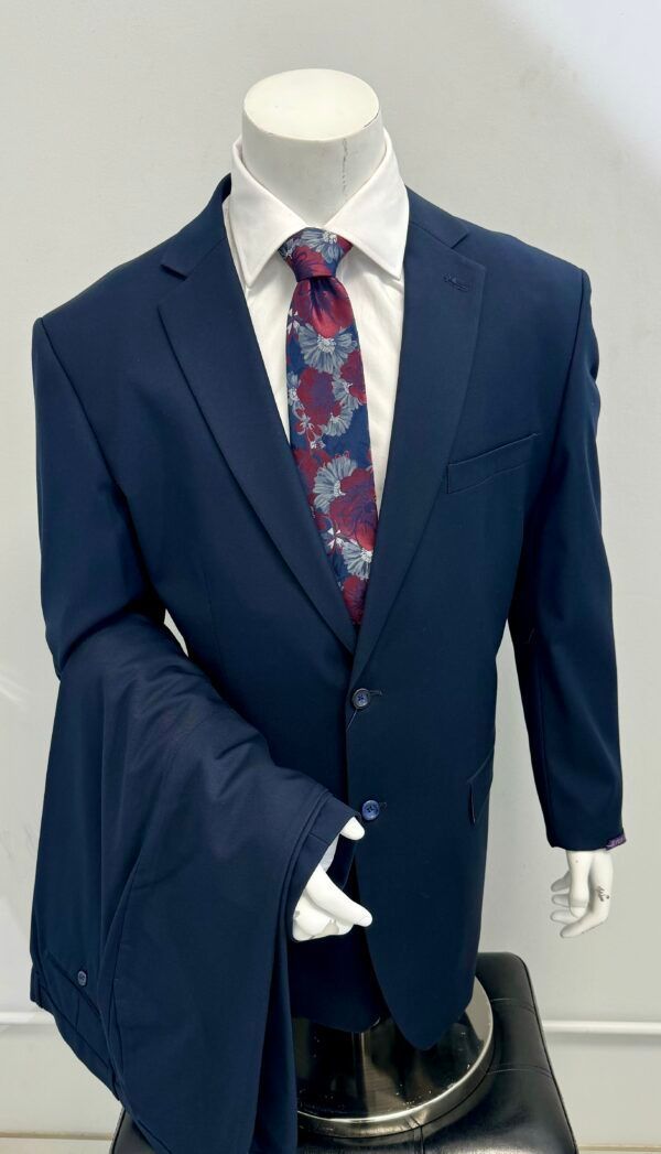 A mannequin is wearing a blue suit and tie.