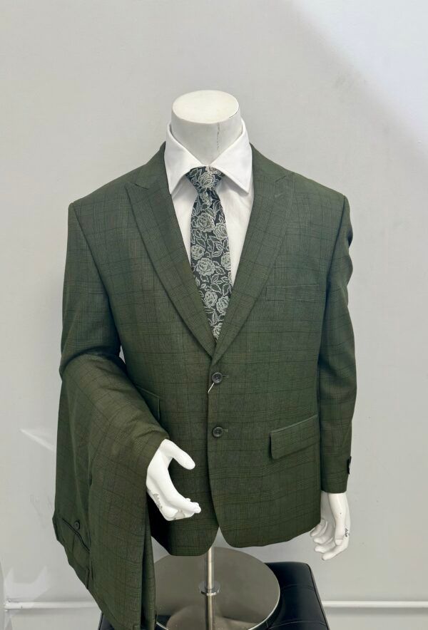 A mannequin is wearing a green suit and tie