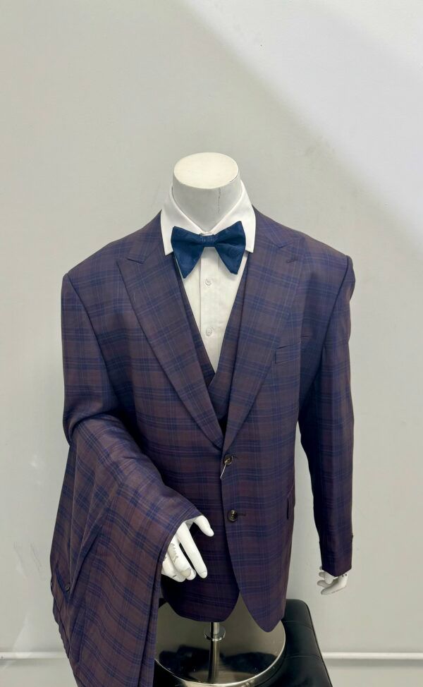 A mannequin wearing a purple suit and bow tie.