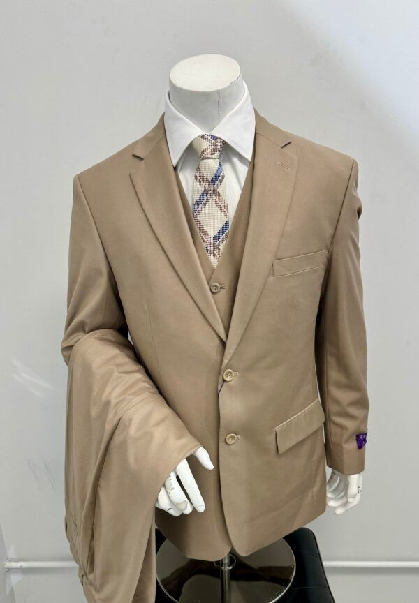 A mannequin is wearing a tan suit and tie
