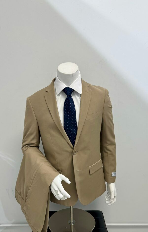 A mannequin is wearing a tan suit and tie.
