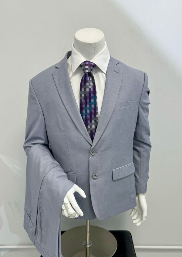 A mannequin is wearing a light blue suit and tie.