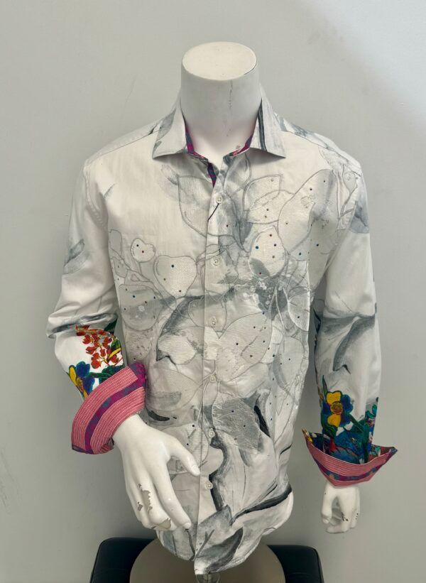 A mannequin is wearing a white shirt with a floral print on the sleeves.