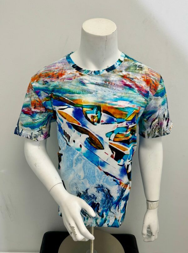 A mannequin is wearing a colorful t-shirt with boats on it