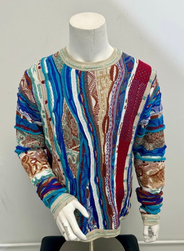 A colorful sweater is on a mannequin.