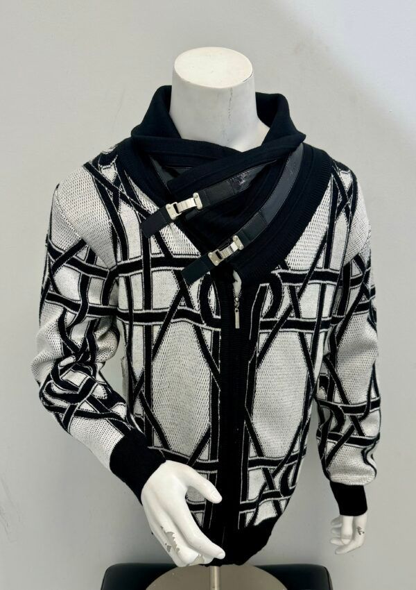 A mannequin is wearing a black and white sweater.