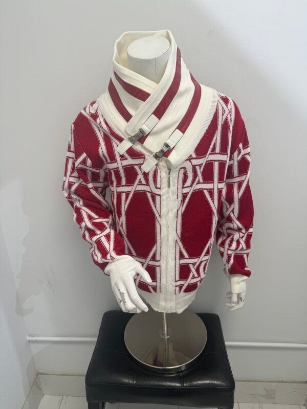 A red and white sweater is on a mannequin