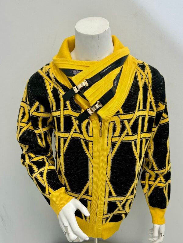 A mannequin wearing a black and yellow sweater with a zipper