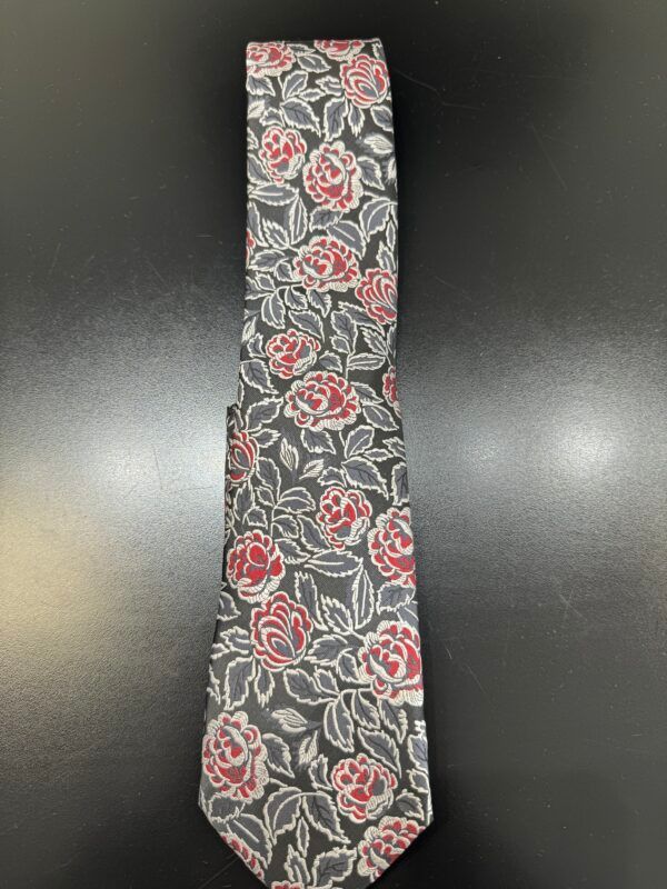 A tie with red and white roses on a black background