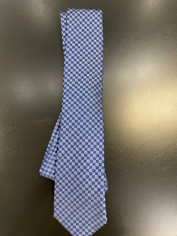 A blue checkered tie is sitting on a black surface
