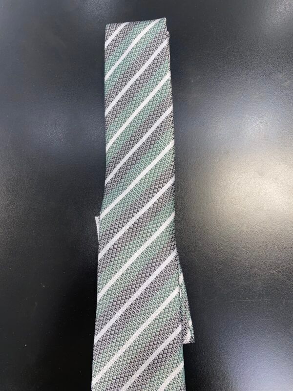 A striped tie is sitting on a black table.