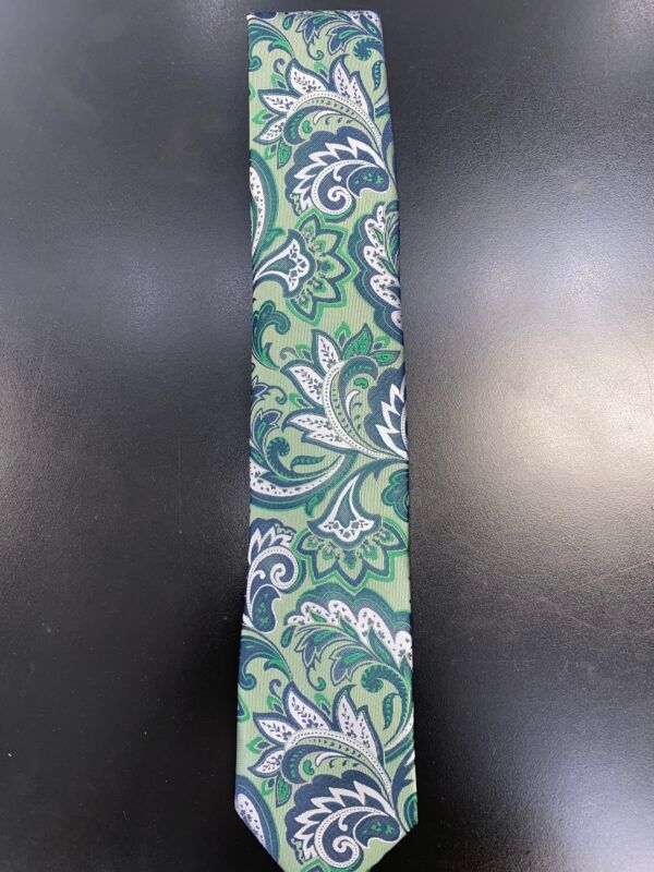 A green and white paisley tie is on a black surface