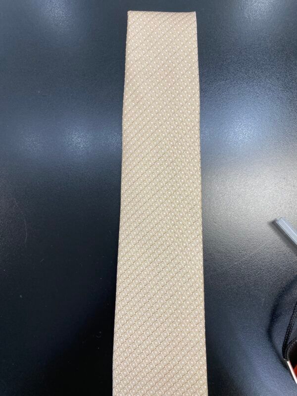 A piece of paper is sitting on a black table next to a pair of scissors.