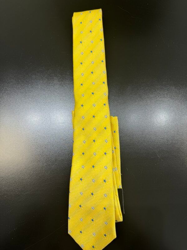 A yellow tie with white polka dots on it