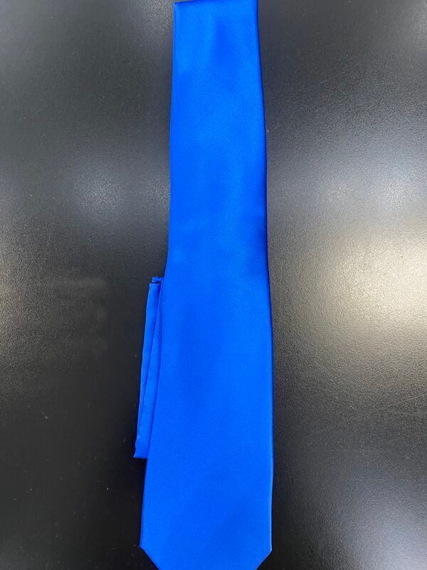 A blue tie is sitting on top of a black table.