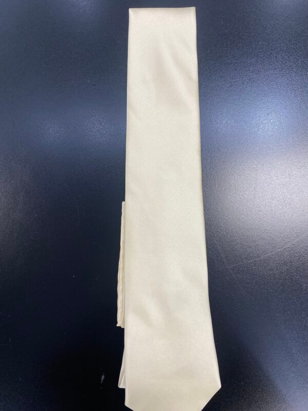 A white tie is sitting on a black surface.