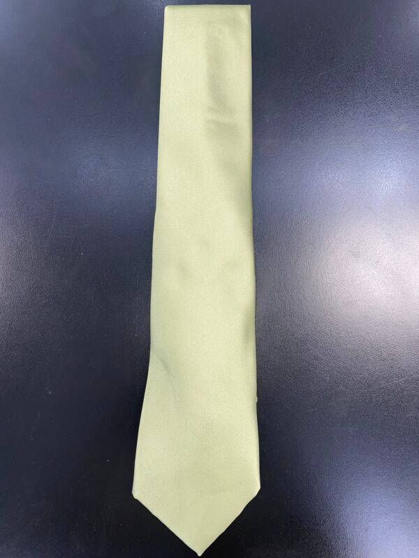 A yellow tie is sitting on a black surface