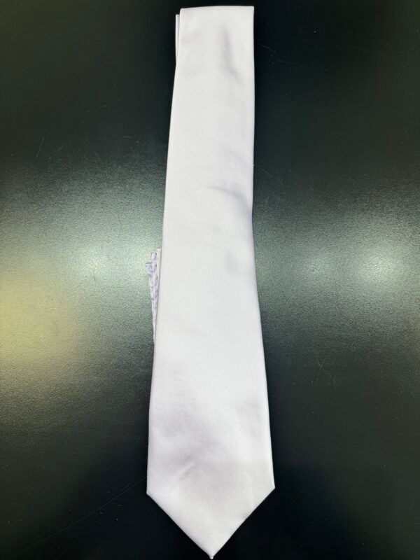 A white tie is sitting on a black table.