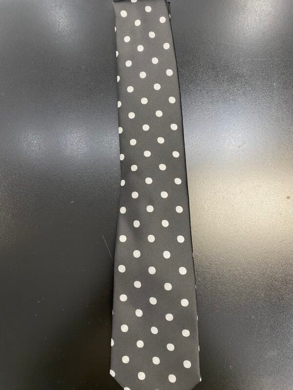 A black tie with white polka dots on it