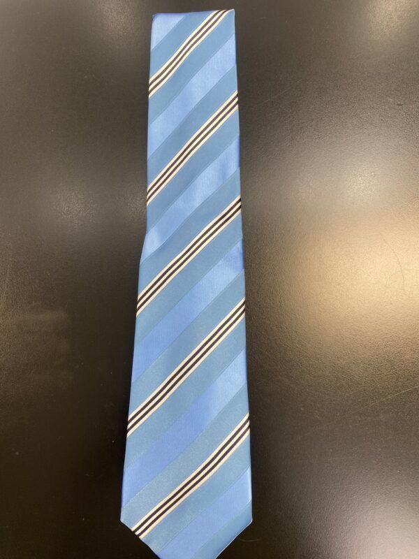 A light blue striped tie is sitting on a black table.