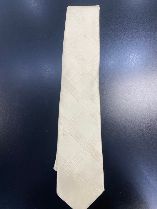 A white tie is sitting on a black surface