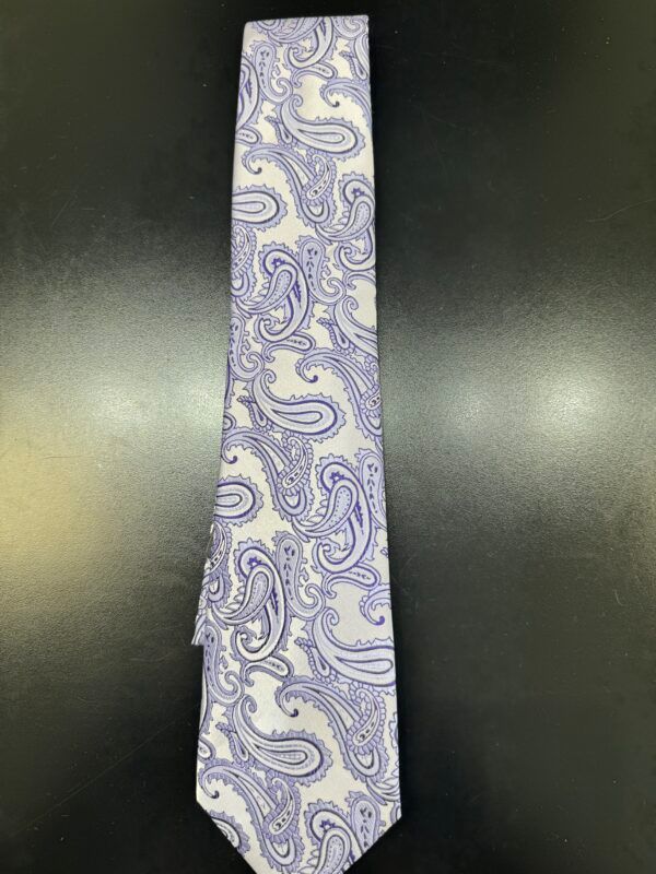 A purple and white paisley tie is sitting on a black table.