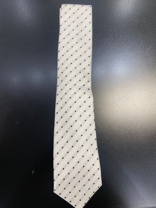 A white tie with black polka dots on it