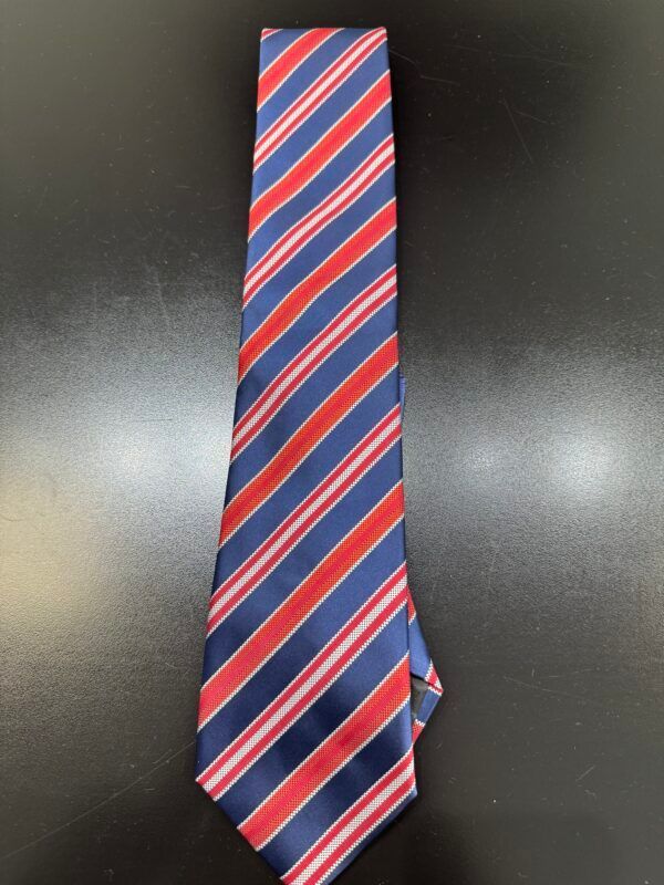 A red white and blue striped tie on a black surface