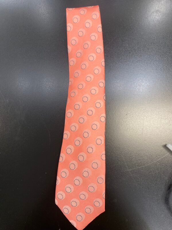 A pink tie with white circles on it