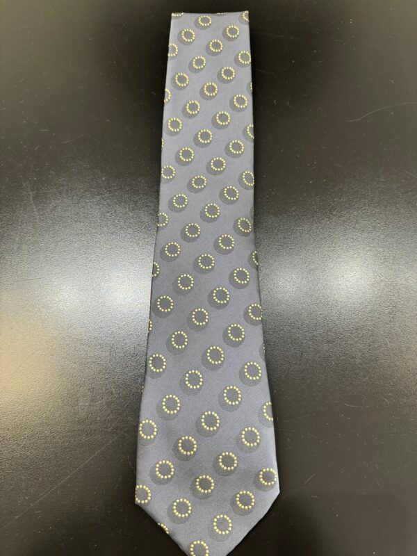 A gray tie with white circles on it