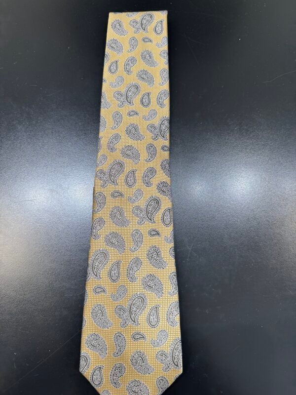 A yellow tie with a paisley pattern on it