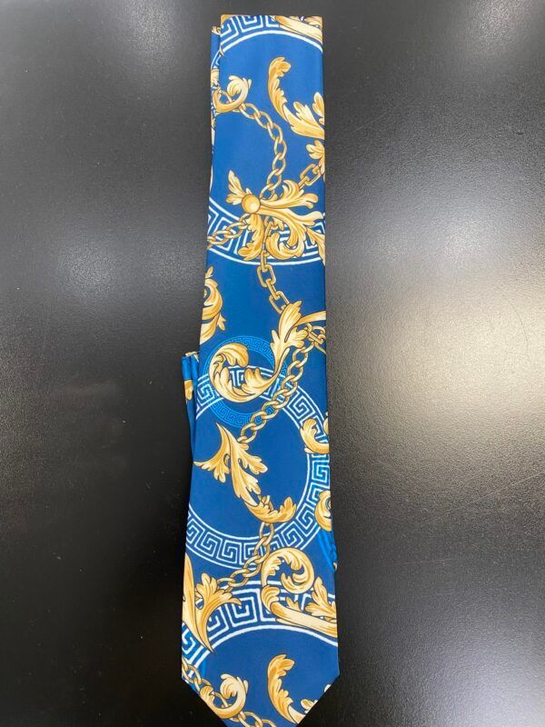 A blue tie with gold chains and leaves on it