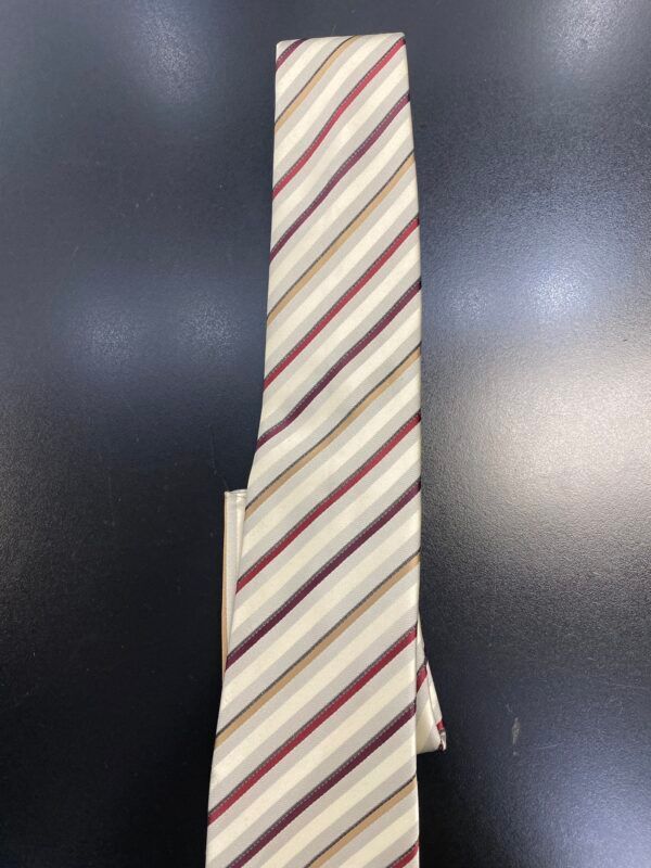 A striped tie is sitting on a black surface