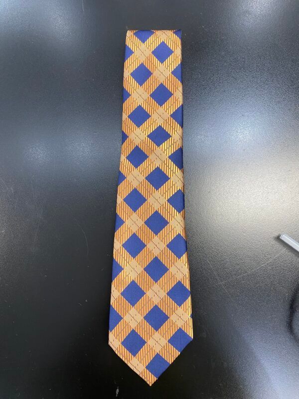 A tie with a plaid pattern is sitting on a table
