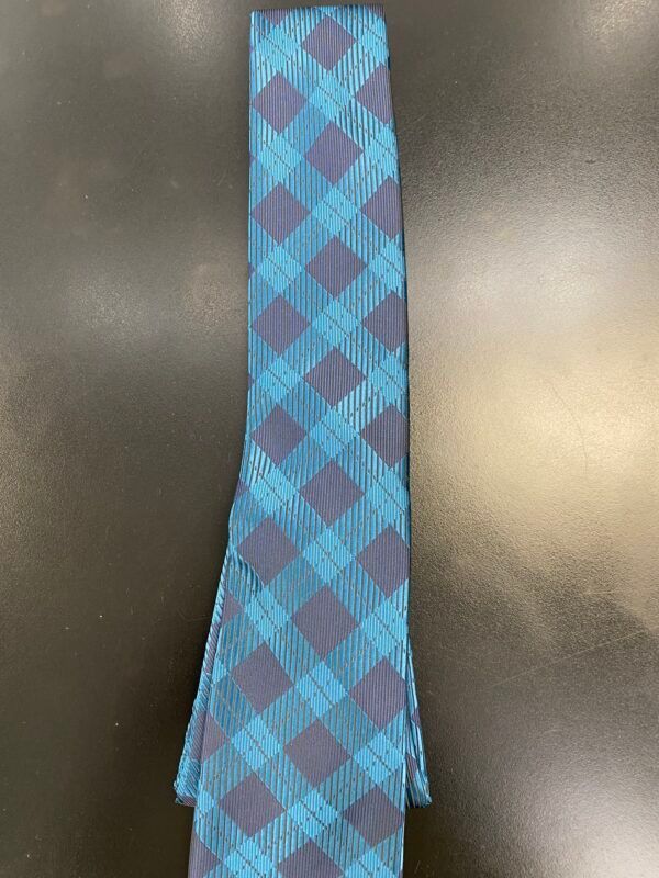 A blue and purple plaid tie is sitting on a black surface