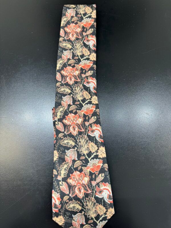 A black tie with flowers and leaves on it