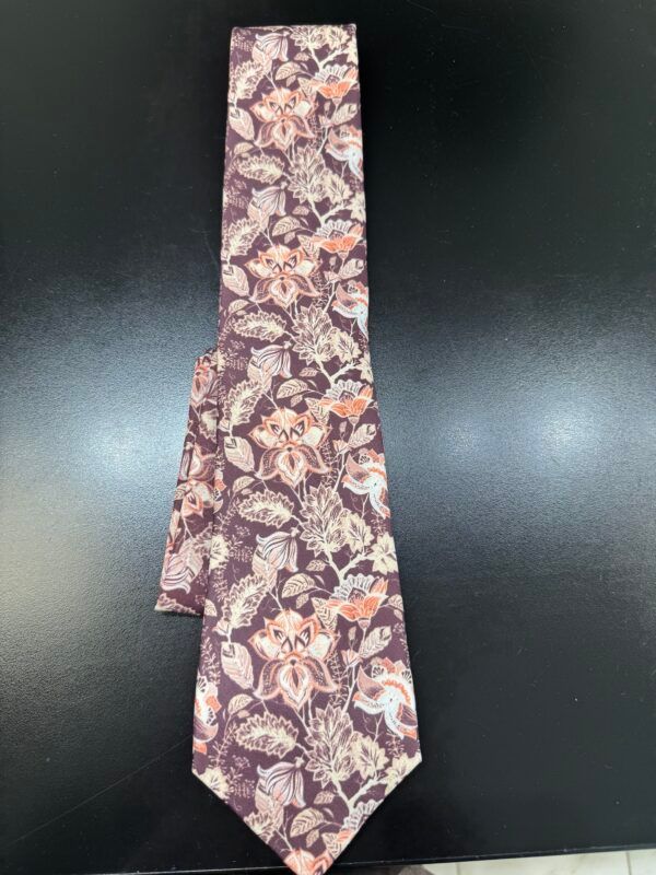 A purple tie with flowers and leaves on it