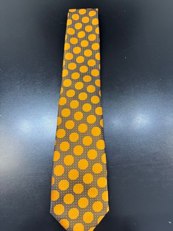 A brown tie with yellow polka dots on it