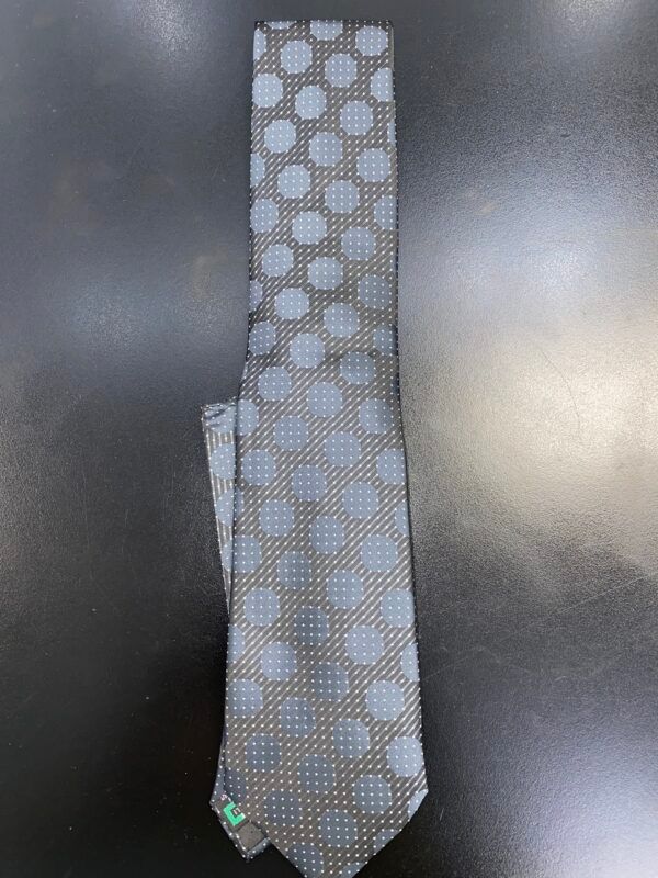 A tie with polka dots on it is sitting on a table.