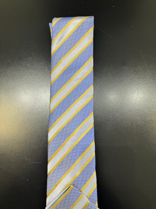 A blue and yellow striped tie is on a black surface
