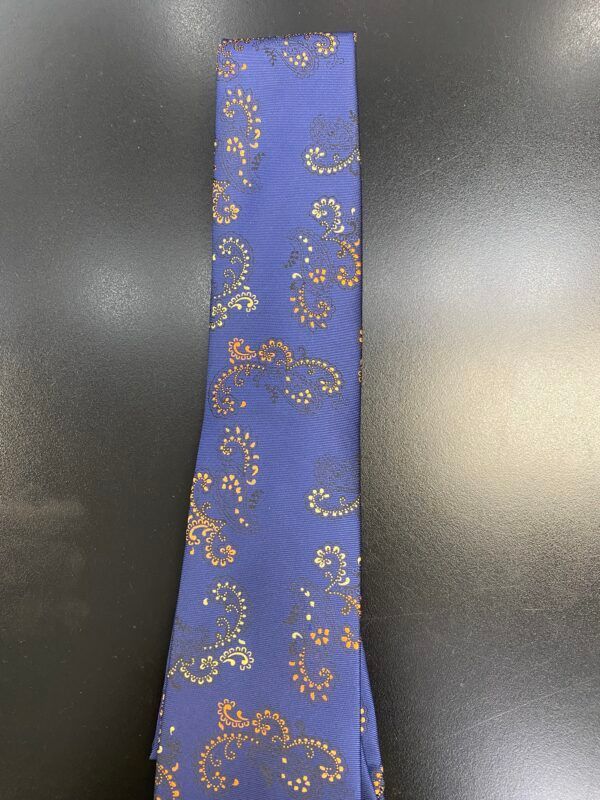 A blue tie with gold swirls on it
