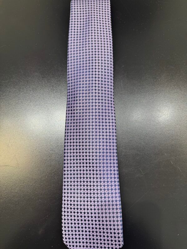 A purple tie is sitting on a black table.