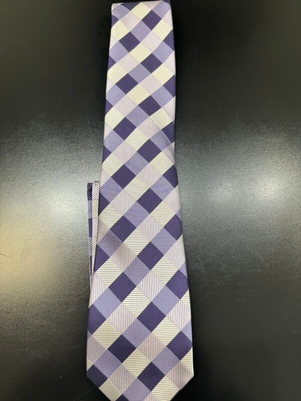 A purple and white plaid tie is on a black surface